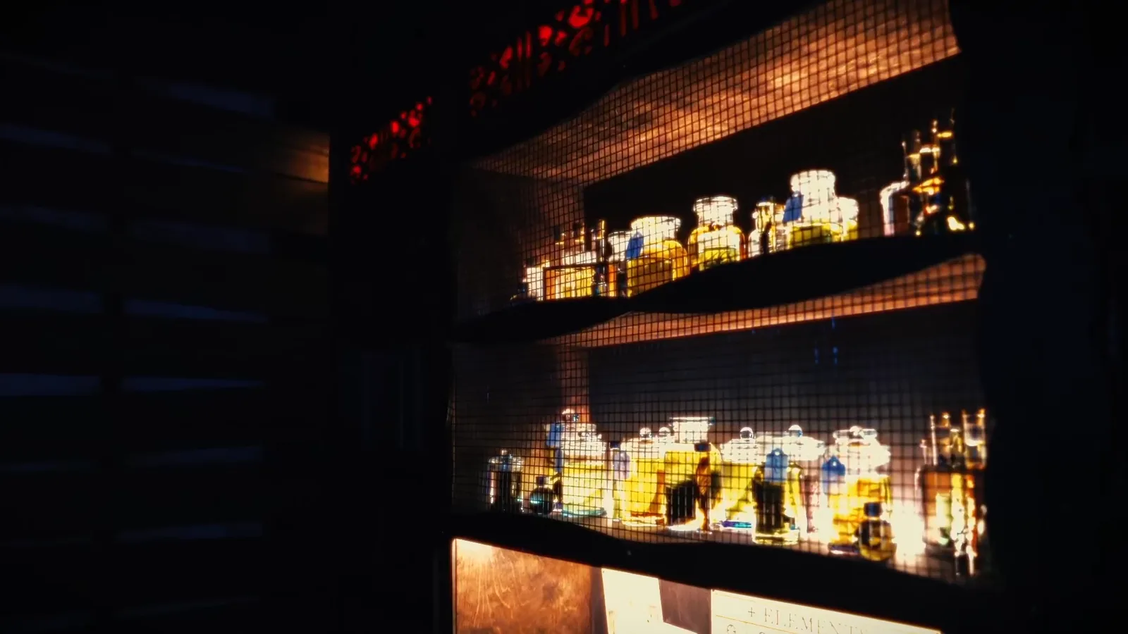 Shelves of glowing chemical bottles in Frankenstein Resurrection
